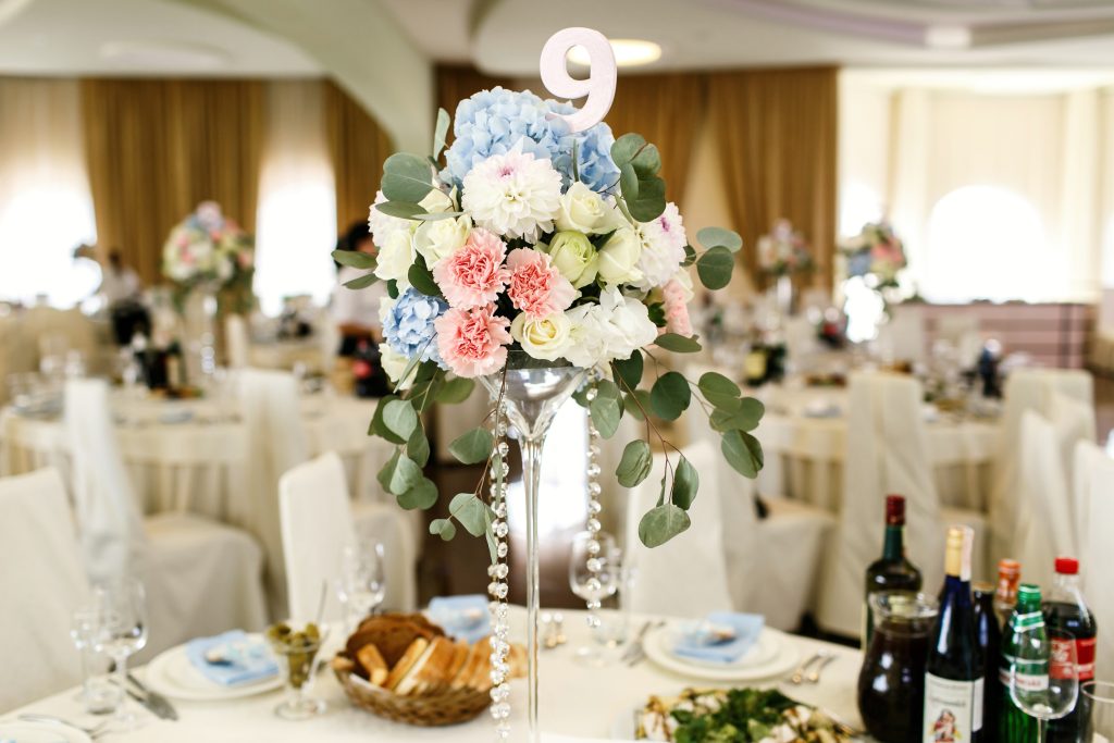 paper number 9 put in a bouquet of pink and blue flowers in the